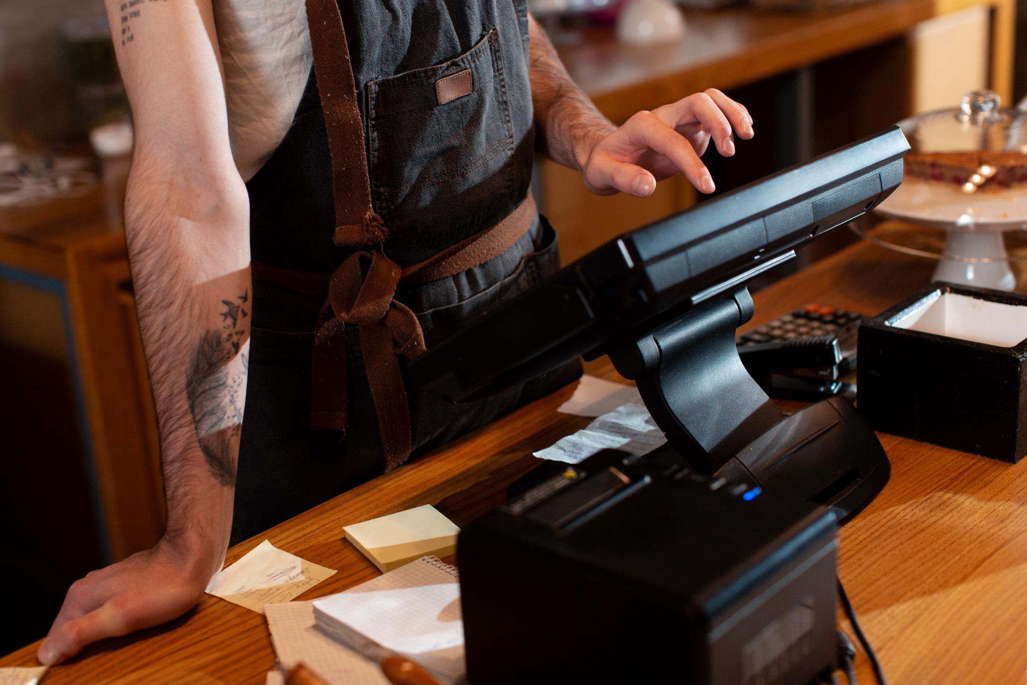 Close-up of hands working at a cash register