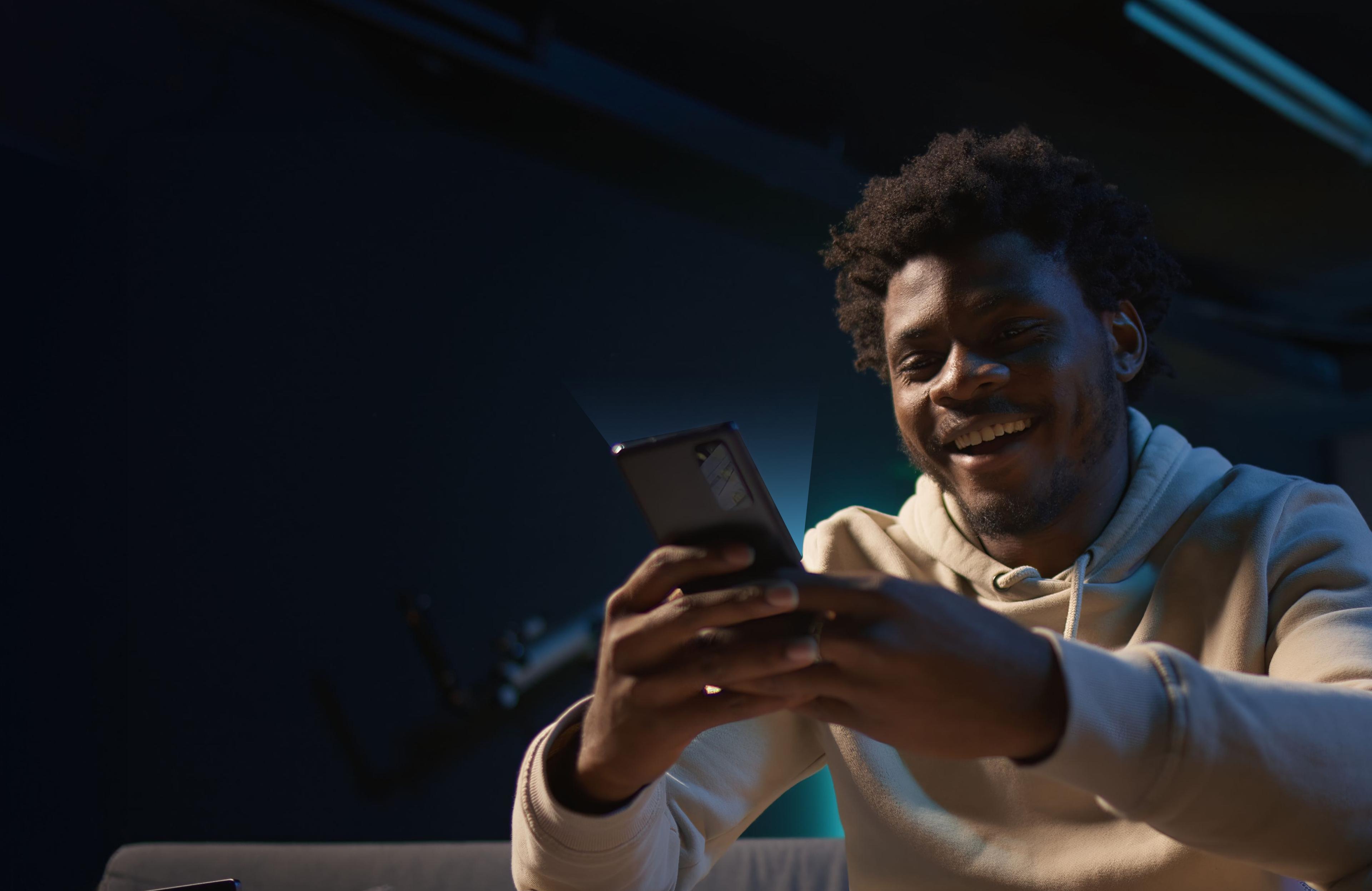 Person smiling while sending a payment link on their phone