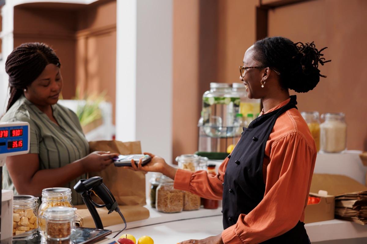 Restaurant server settling a bill with a card payment