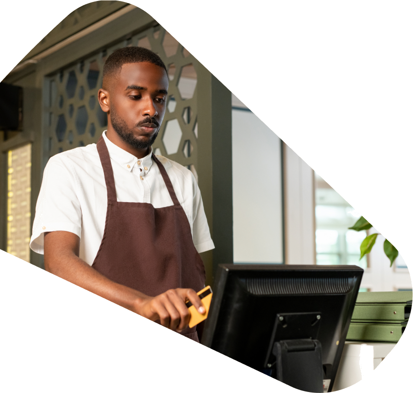 Merchant accepting a card payment at the counter