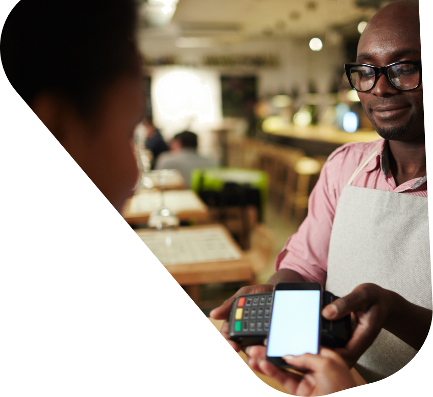 Customer paying by phone at a handheld terminal