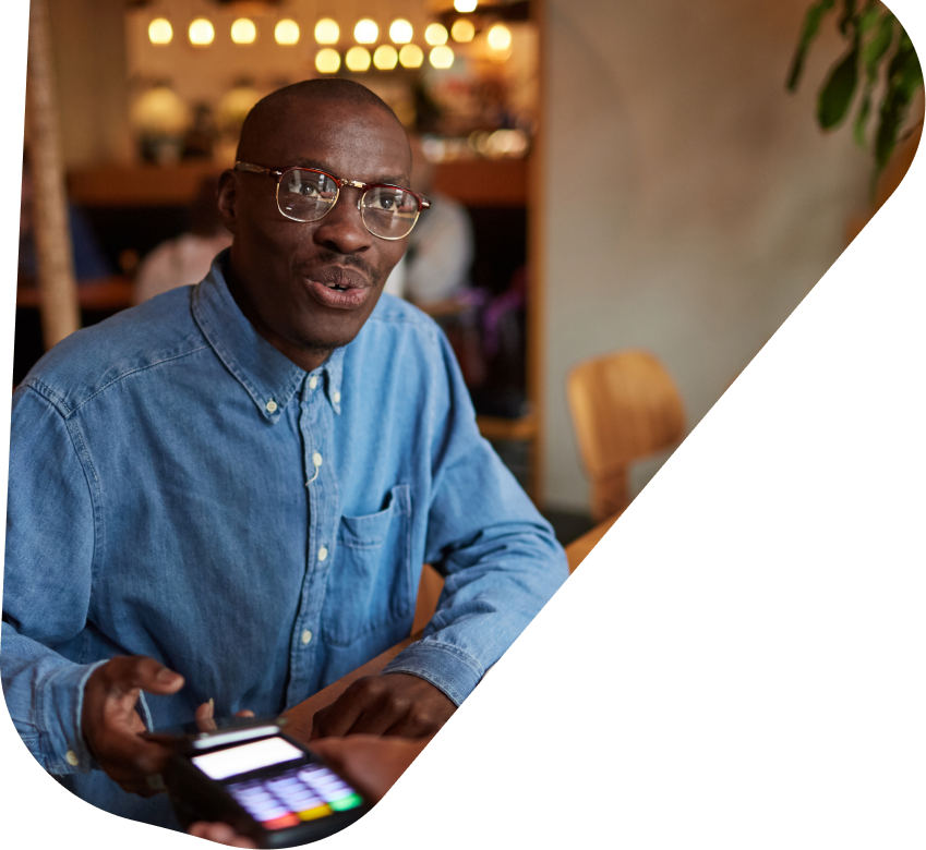 Business owner smiling with a payment terminal